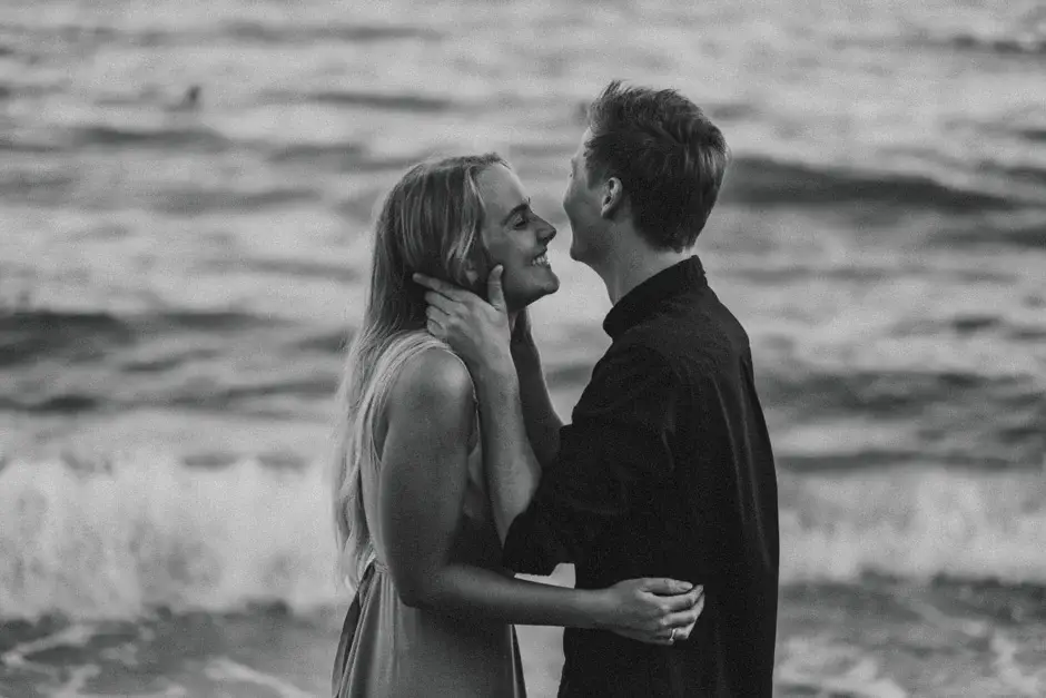 The two of them laughing at the water’s edge, black and white