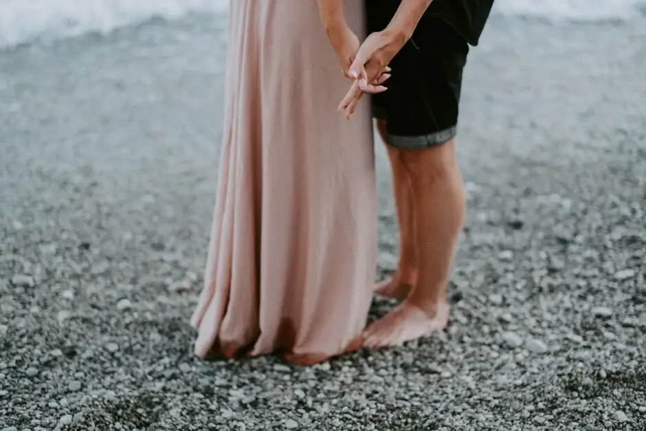 Their hands joined and her bare feet on the pebbles, Amalfi Coast