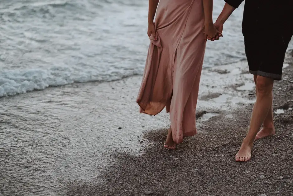 The hem of her dress and their bare feet in the shallows
