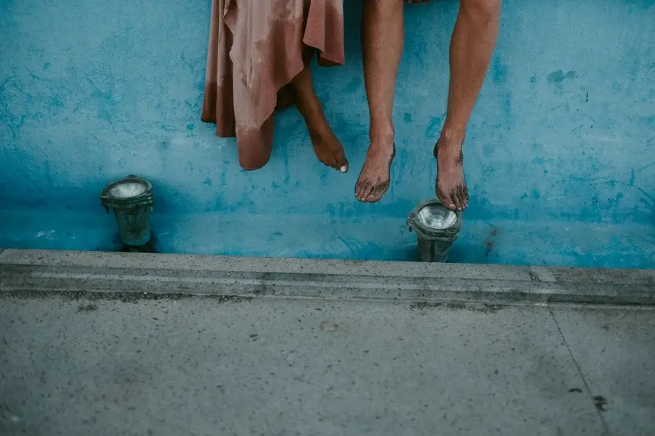 Their feet hanging over the edge of the blue steps, Amalfi Coast
