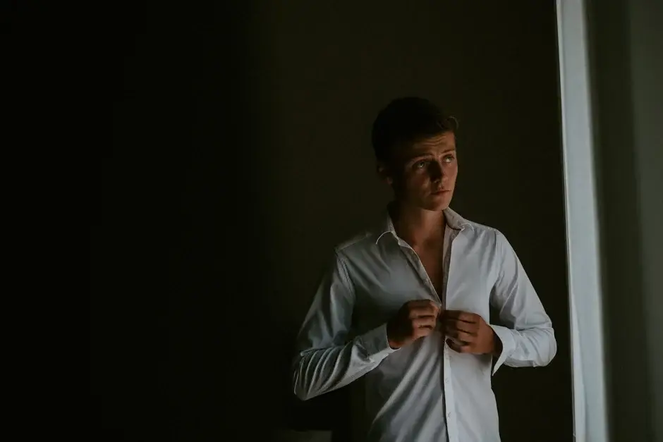 Henrik buttoning his shirt in the window light, Ravello