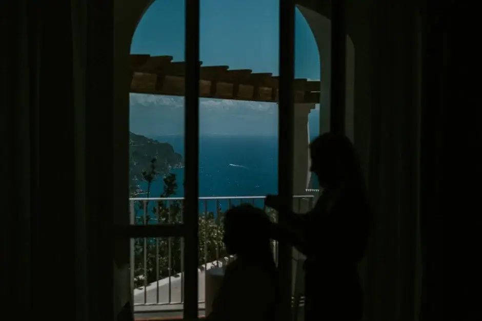 A woman at the arched window above the sea, Ravello