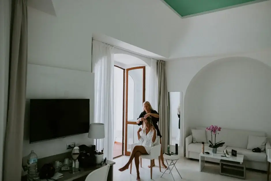 Emilie getting ready in a bright white room, Ravello