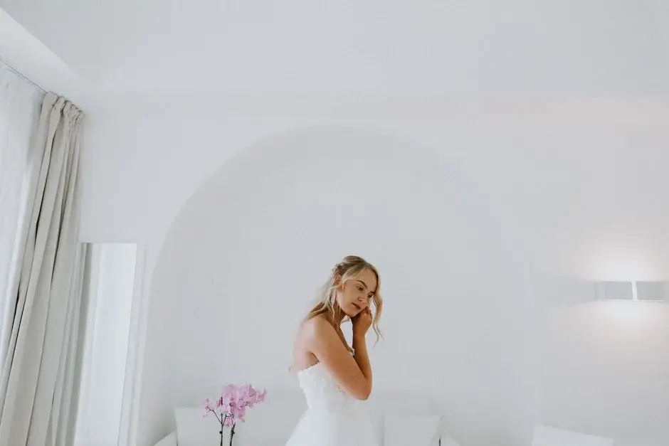Emilie in her gown in a white arched room, Ravello