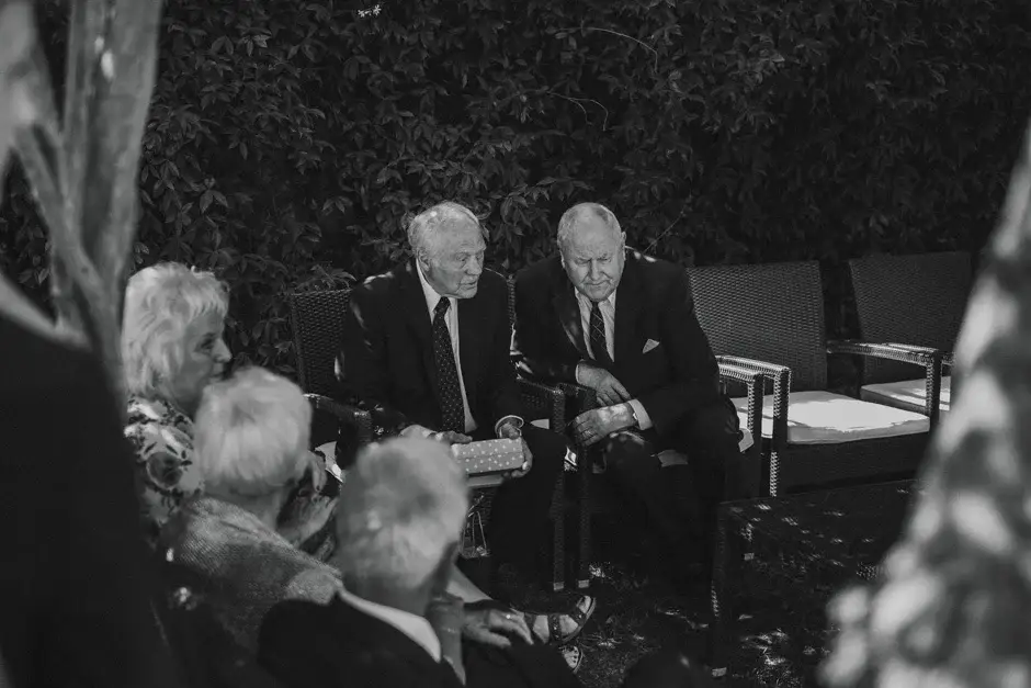 Guests seated in the garden before the ceremony, black and white