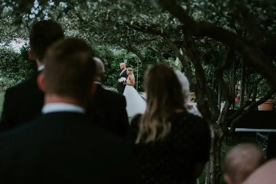 Guests turning to watch Emilie arrive, Ravello