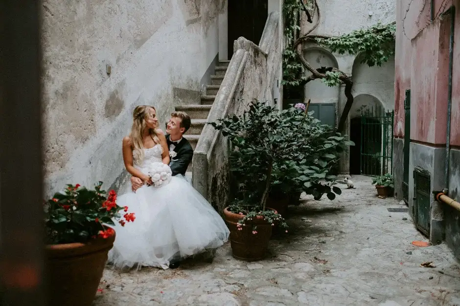 The two of them sitting on stone steps among the pots, Ravello