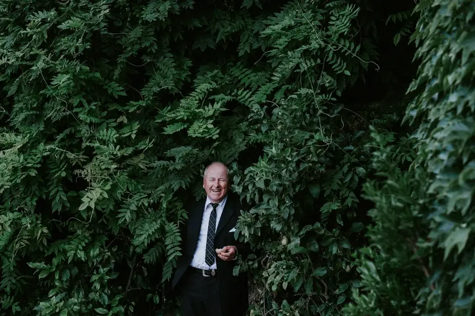 A guest laughing against a wall of greenery, Ravello