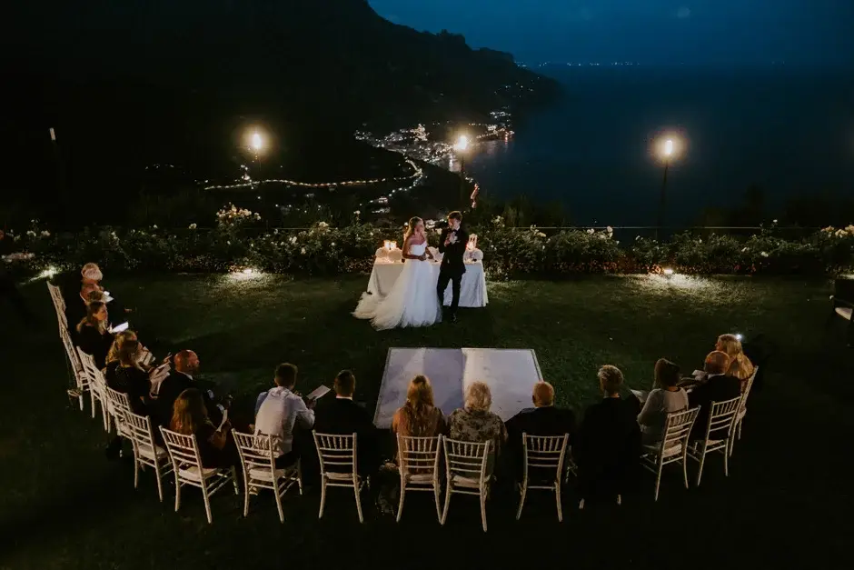 The reception at night with the coastline lit below, Ravello