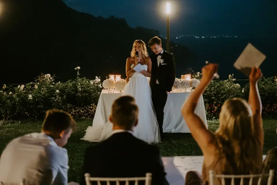 Guests cheering at the cake table after dark, Ravello