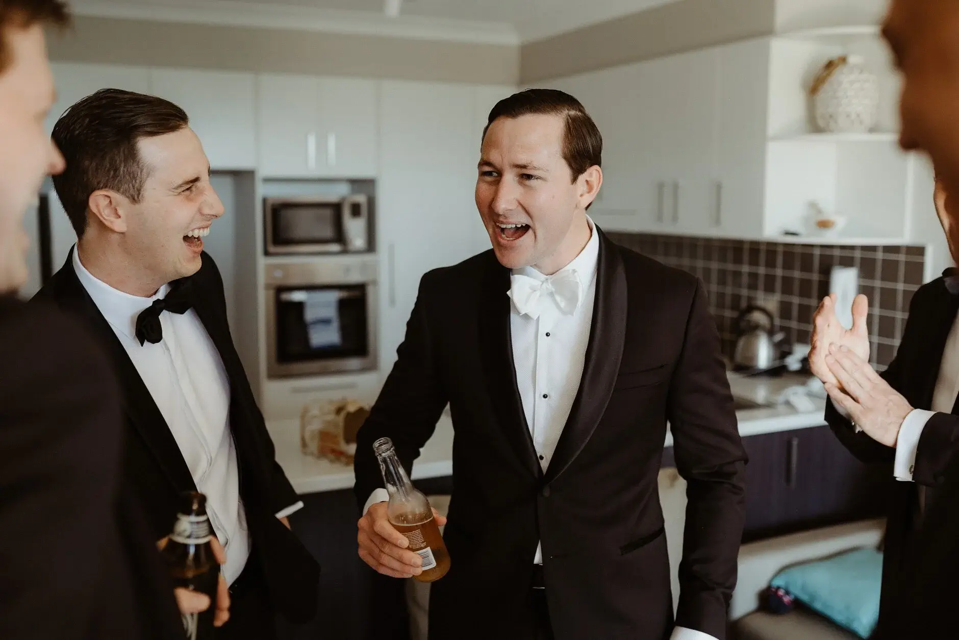 James and a groomsman laughing with drinks in hand, Burleigh Heads