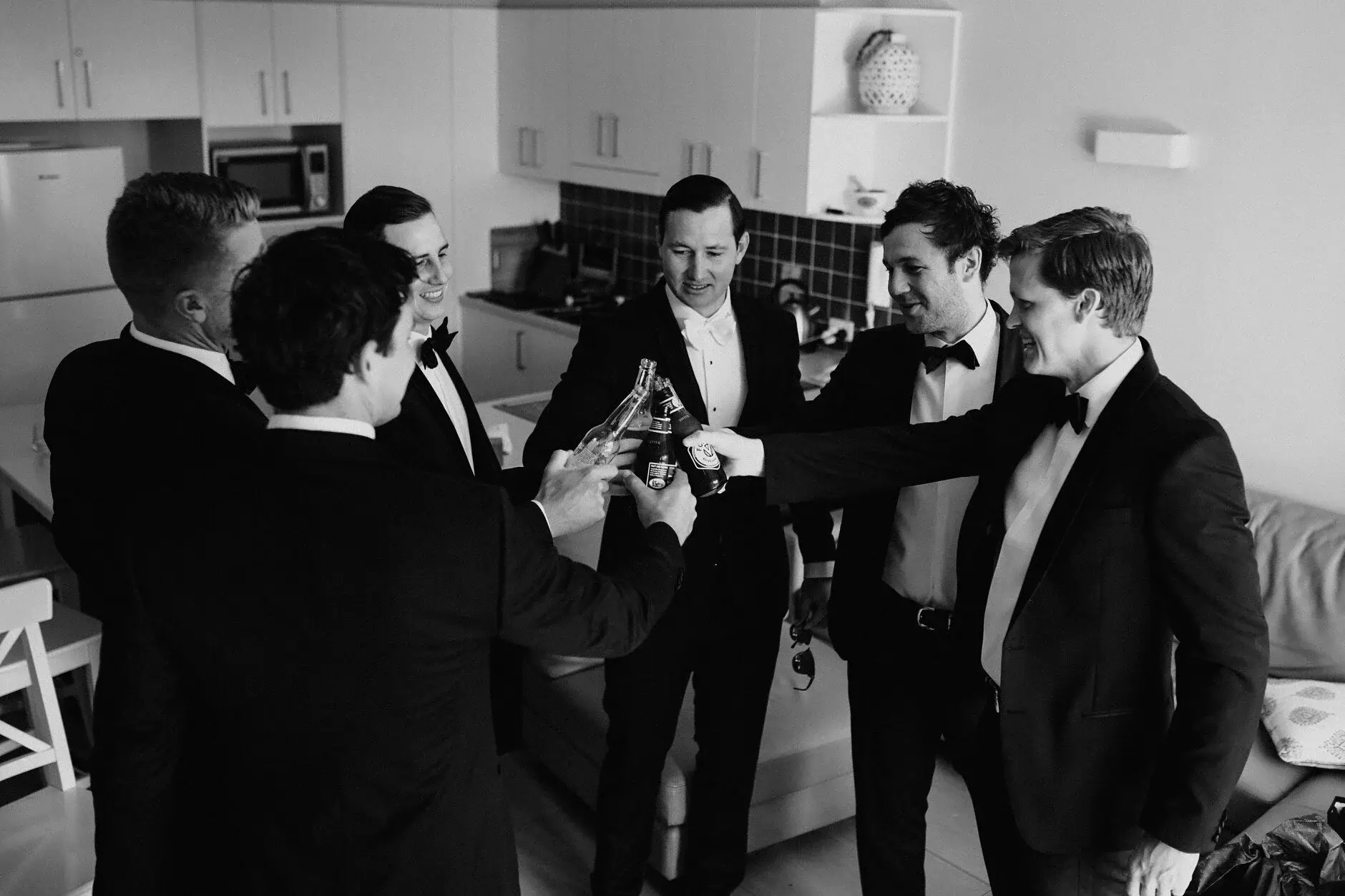 The groomsmen opening a bottle in the kitchen, Burleigh Heads