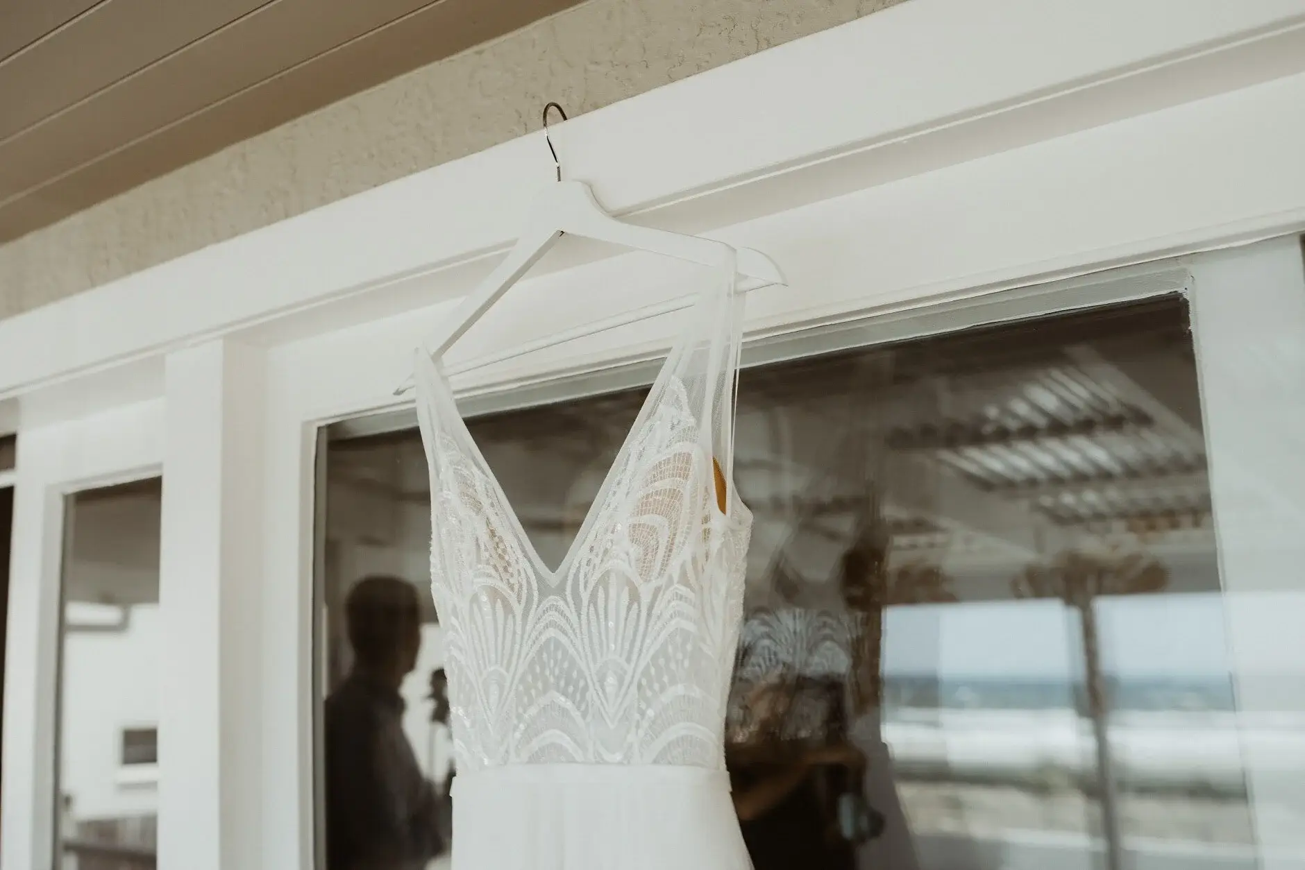 Clair’s gown hanging in the window above the beach, Burleigh Heads