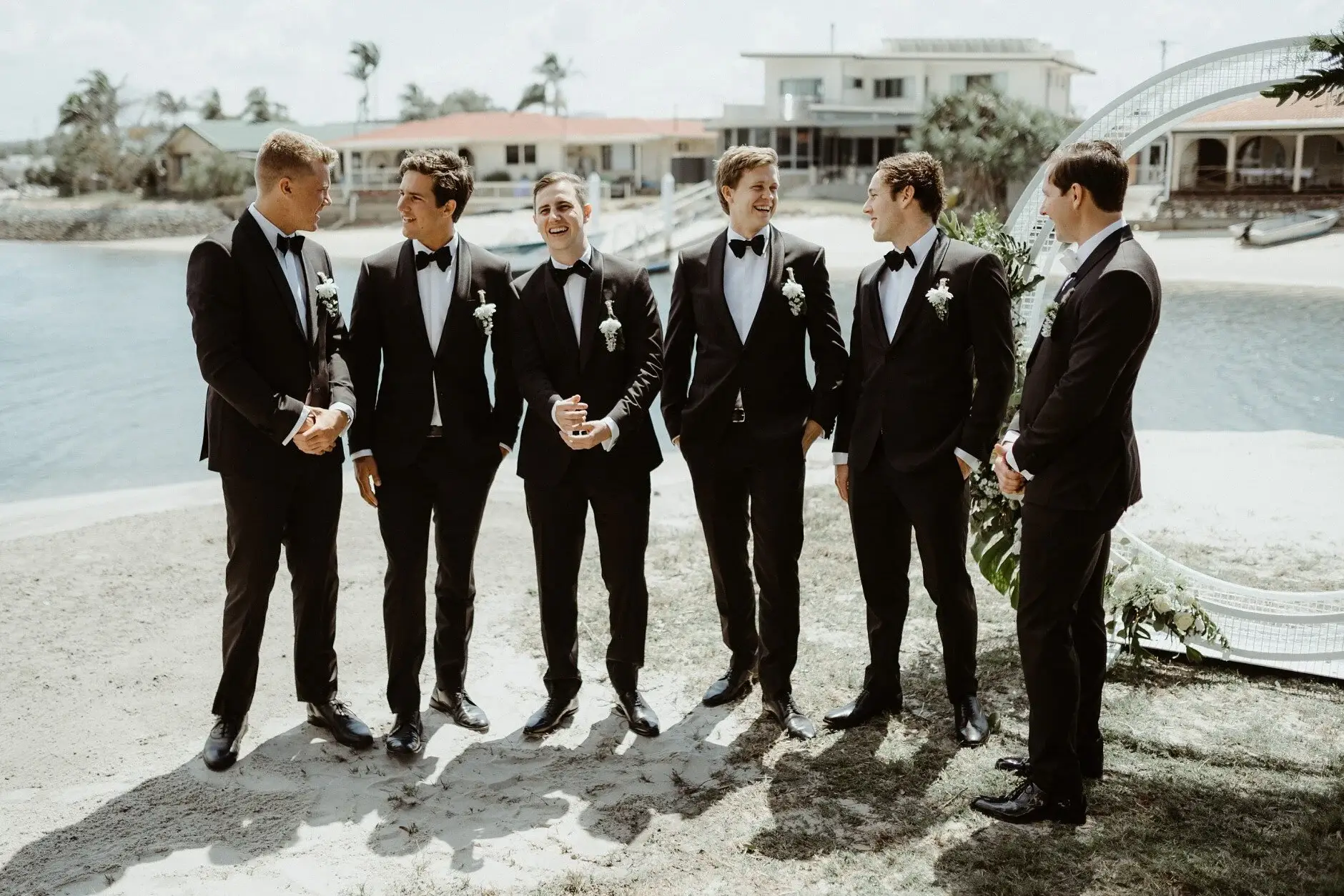 The groomsmen lined up along the canal before the ceremony