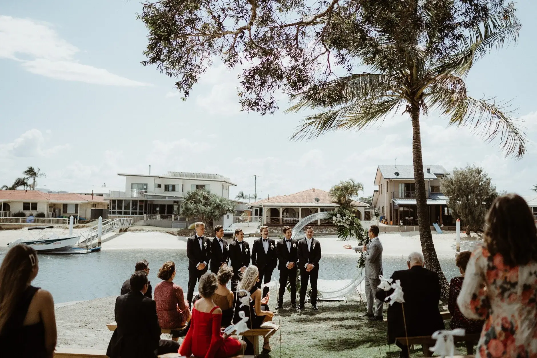 Guests gathering under the palms for the ceremony, Burleigh Heads