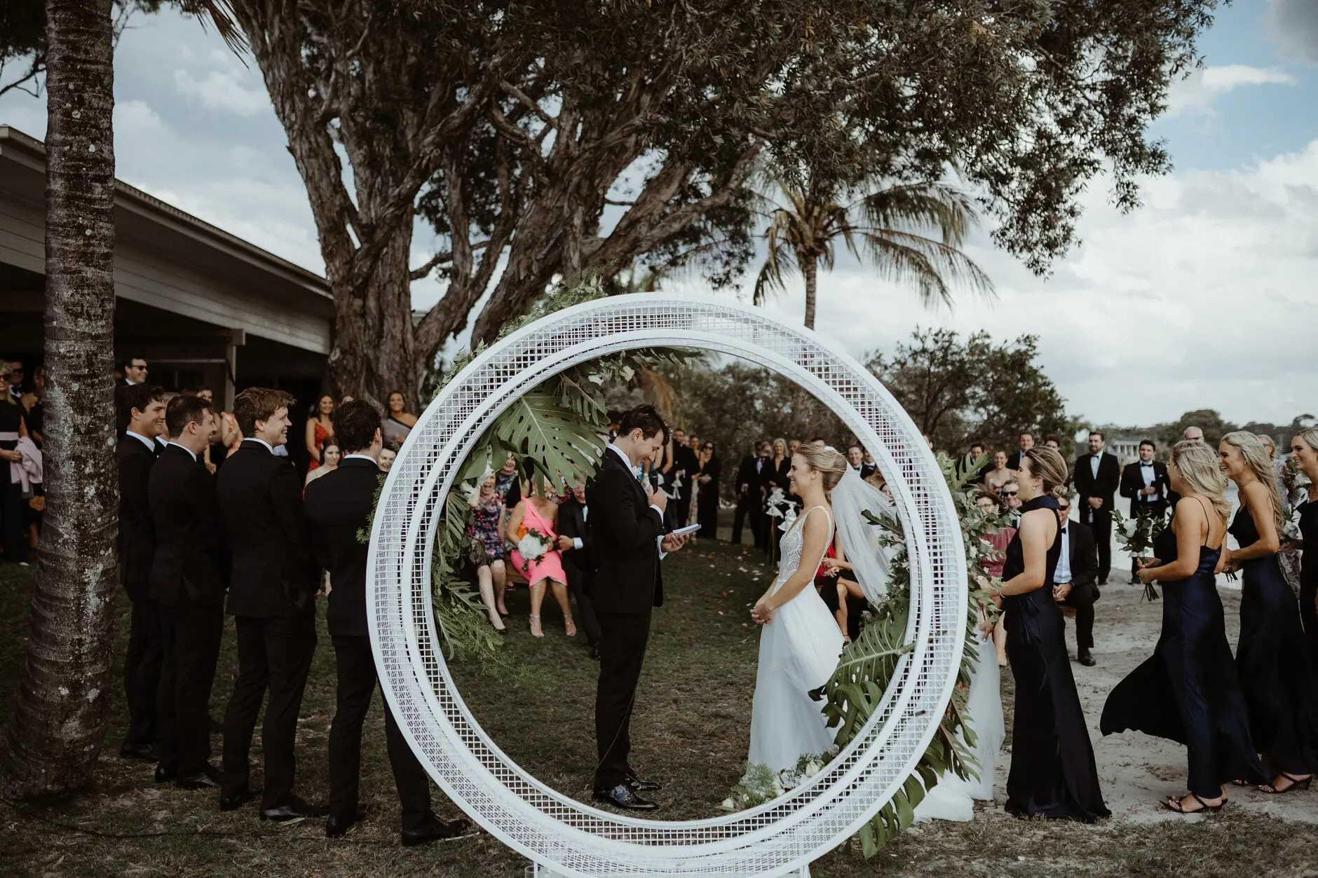 The ceremony at the round floral arch by the water, Burleigh Heads