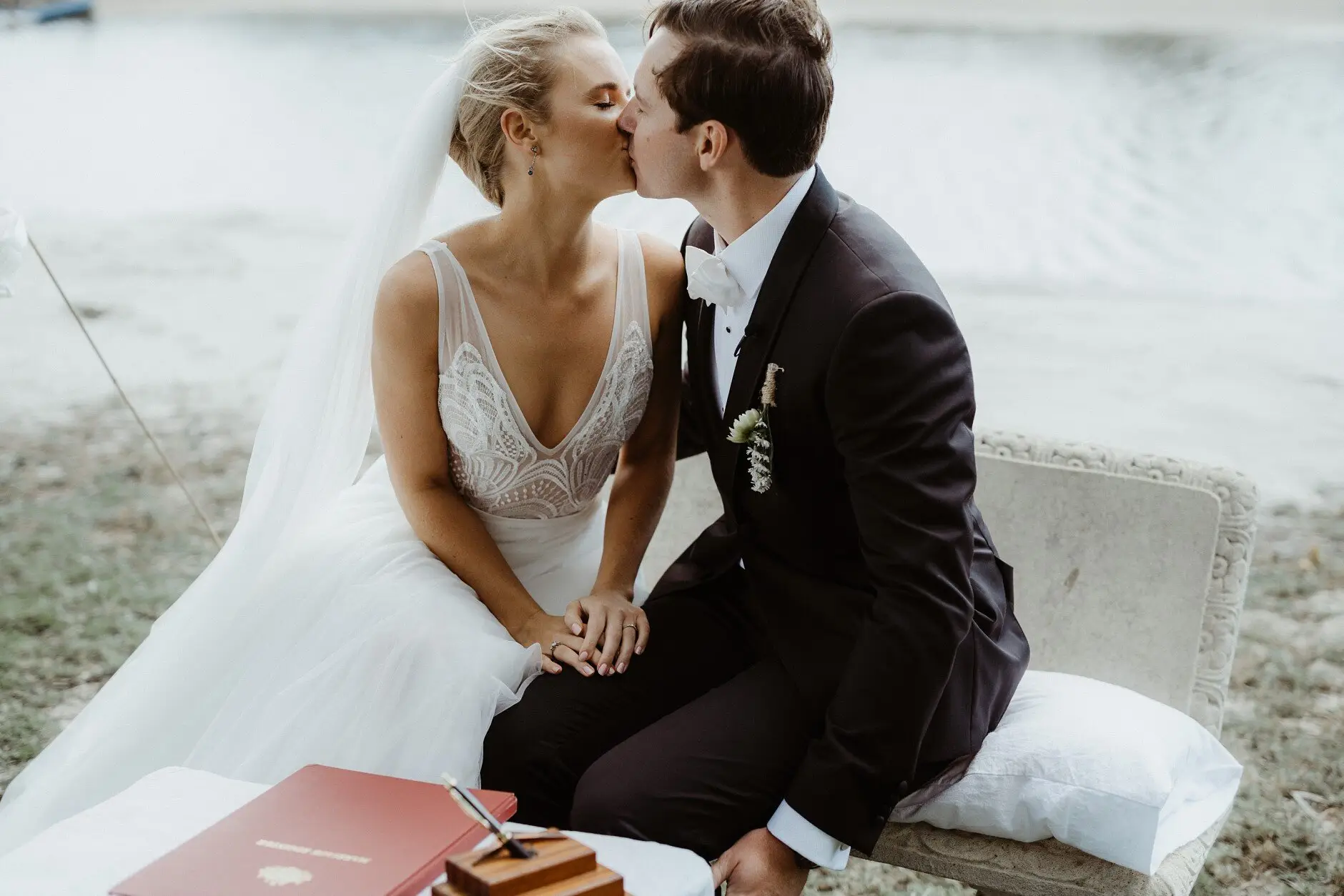Clair and James kissing on the bench after the ceremony