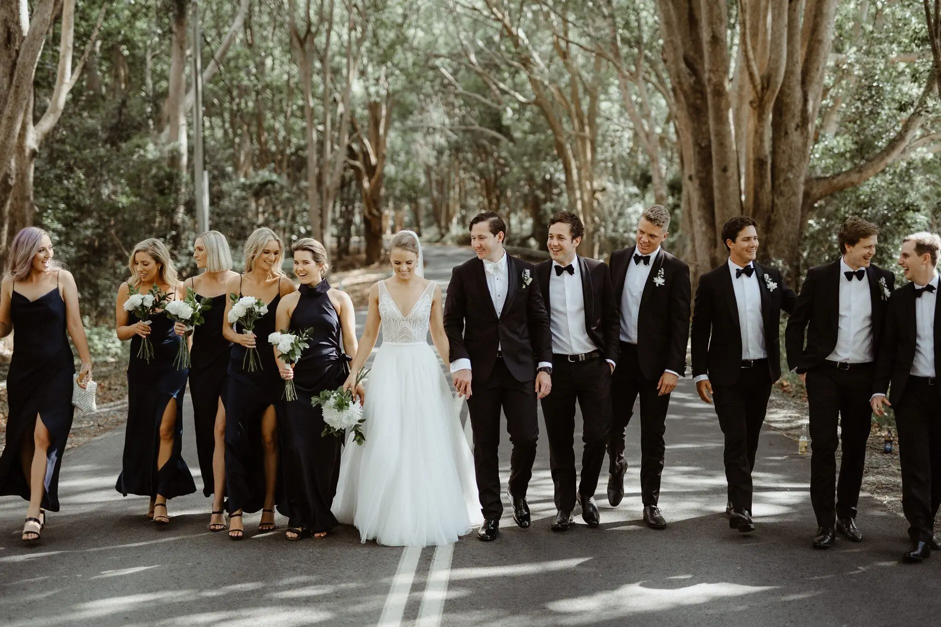 The bridal party walking the tree-lined road, Burleigh Heads