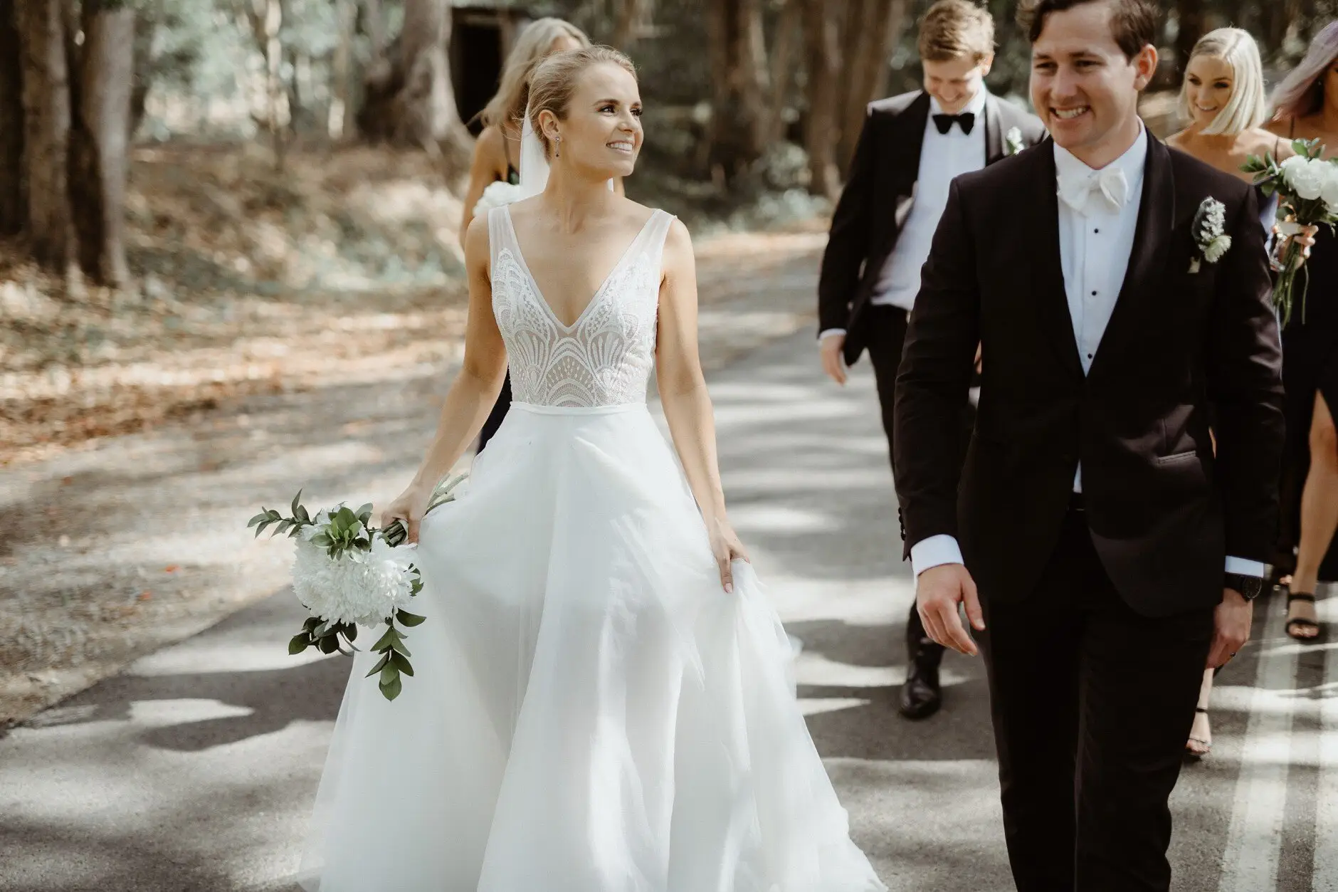 Clair and James walking the road together after the ceremony