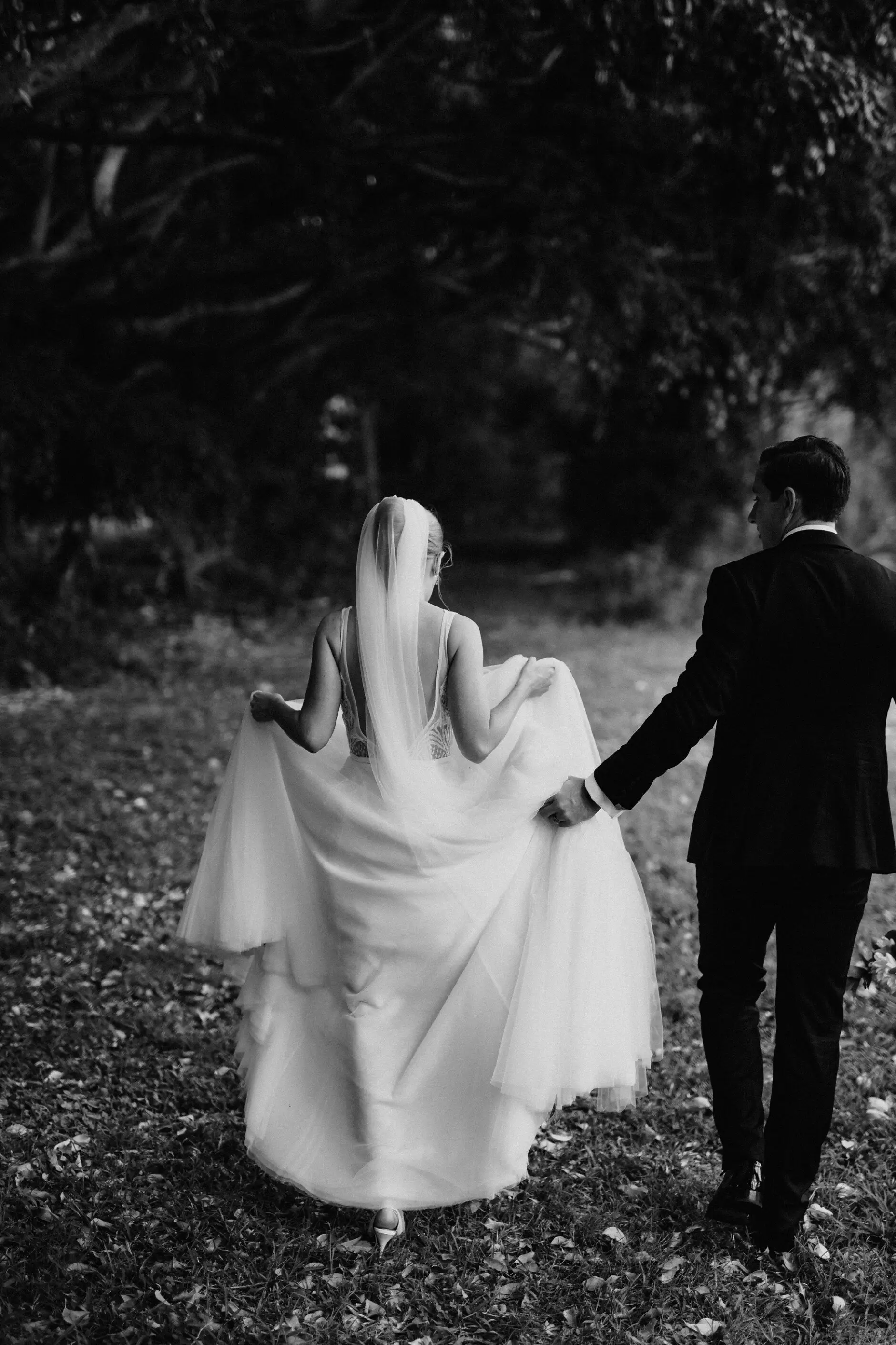 Clair and James walking away hand in hand, Burleigh Heads
