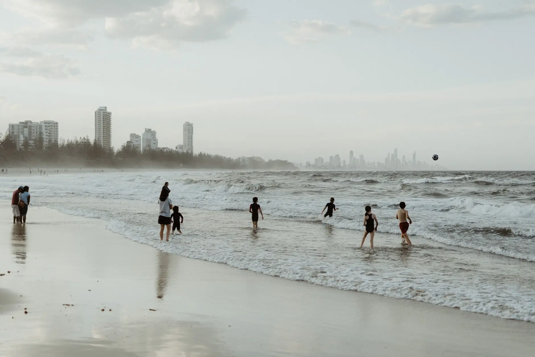Swimmers in the water at Burleigh with the Surfers skyline behind