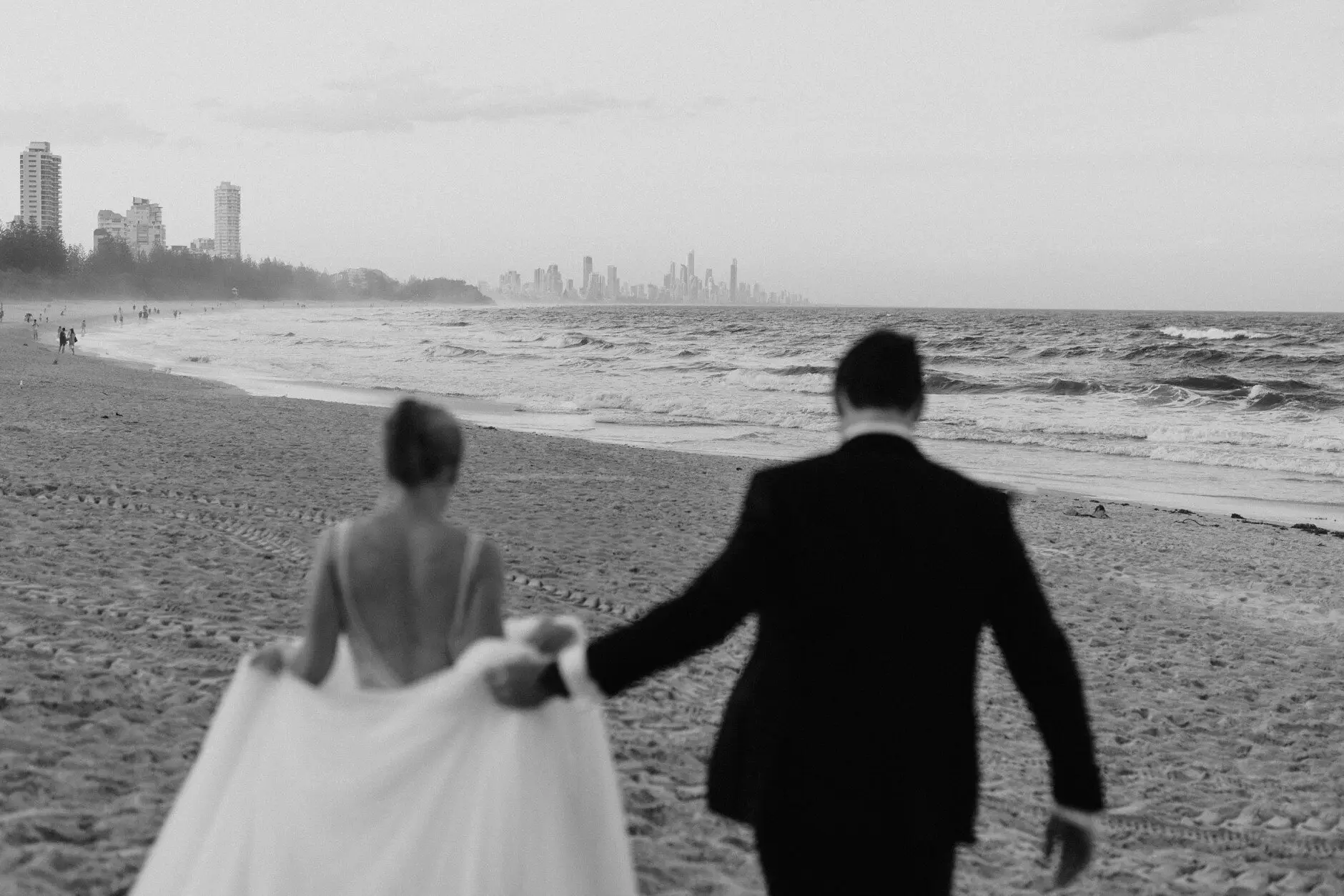 Clair and James walking the beach at dusk, Burleigh Heads