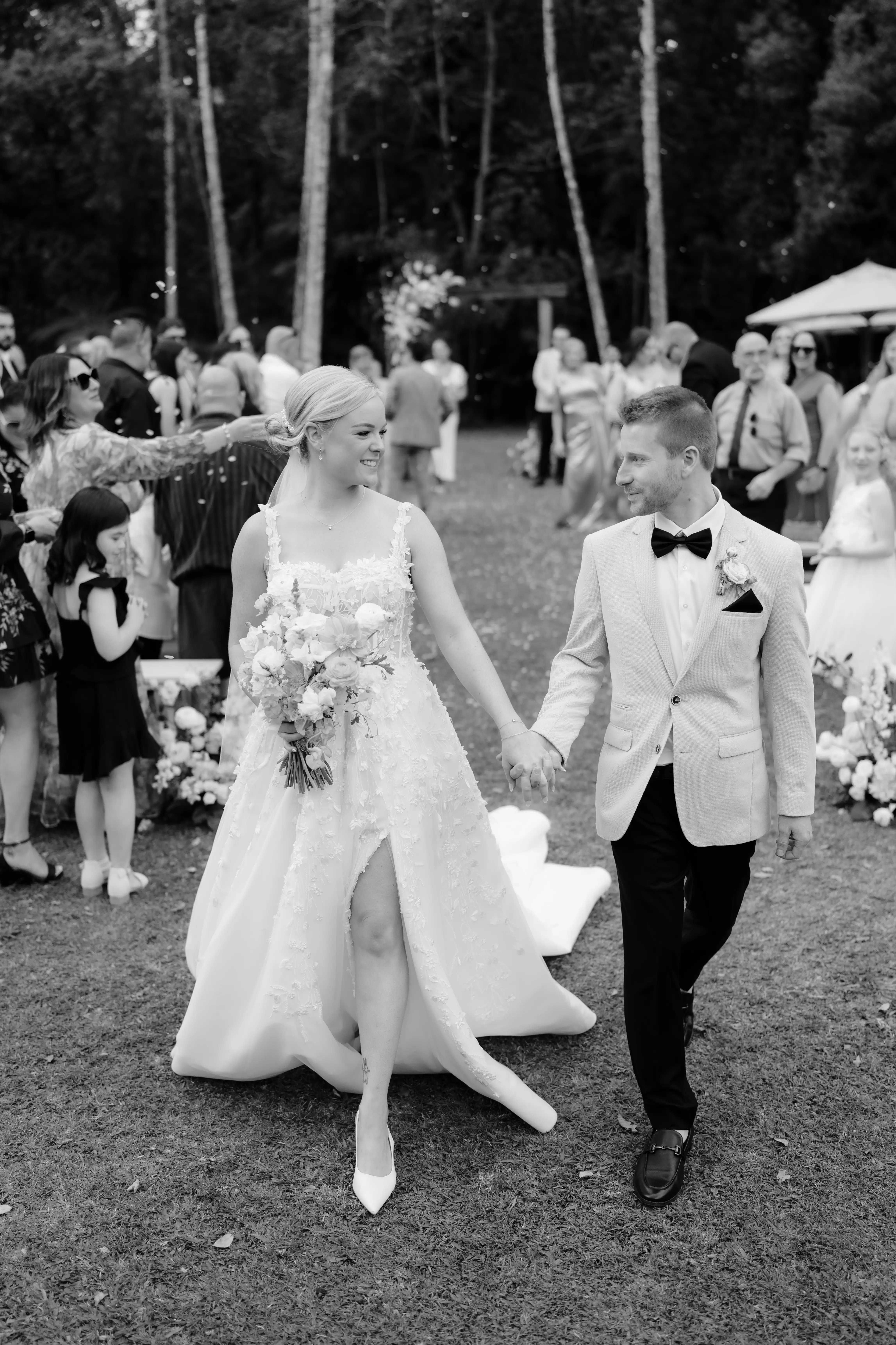 The couple hand in hand back up the aisle through the confetti, The Acre Boomerang Hills