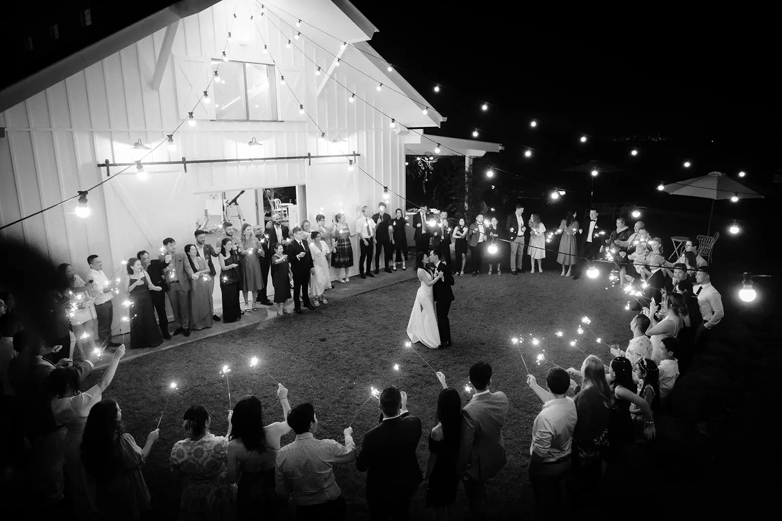 Black and white — sparklers held up around the couple outside the barn, Summergrove Estate, Carool