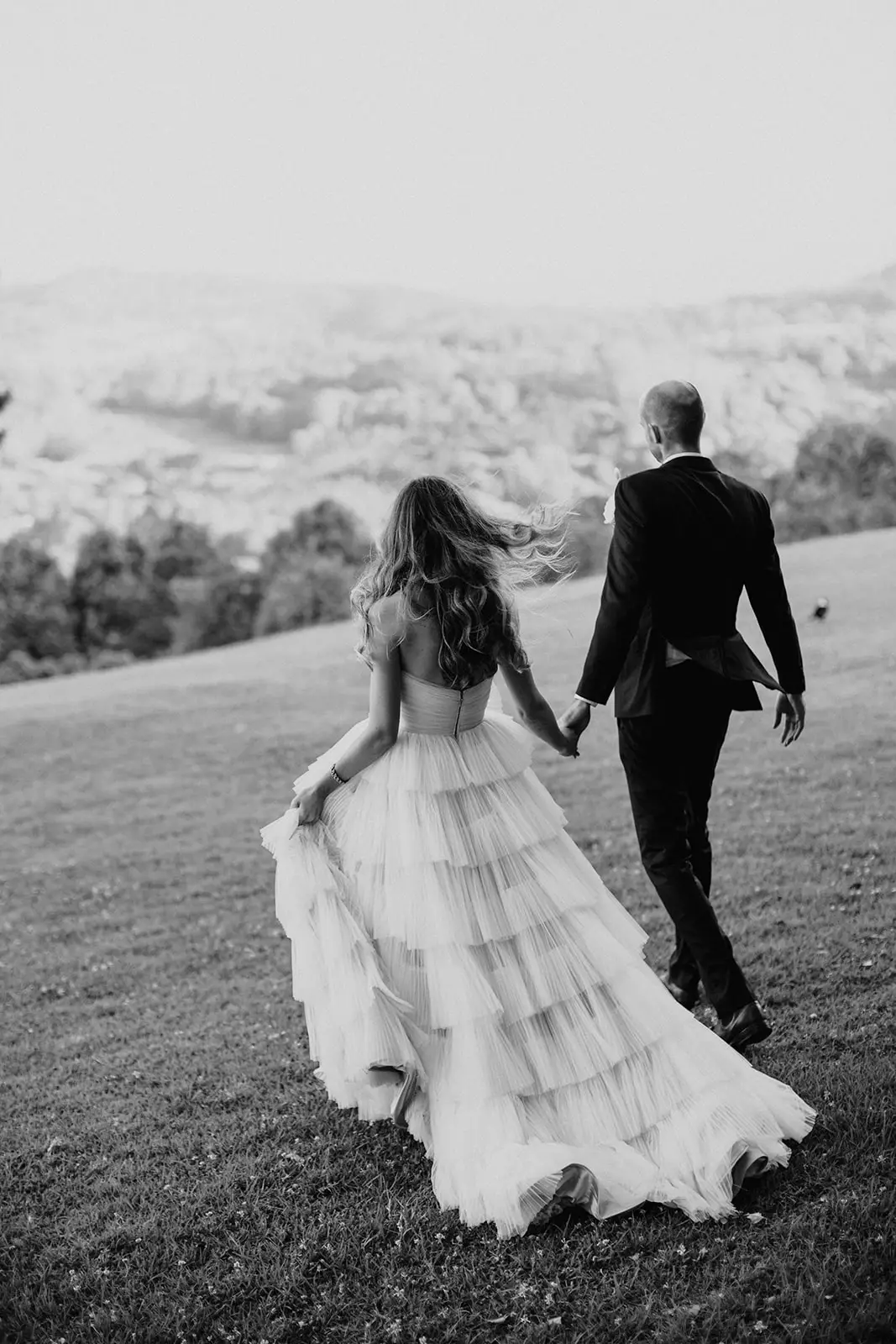 Black and white — crossing the mown lawn hand in hand with the ranges behind, Summergrove Estate