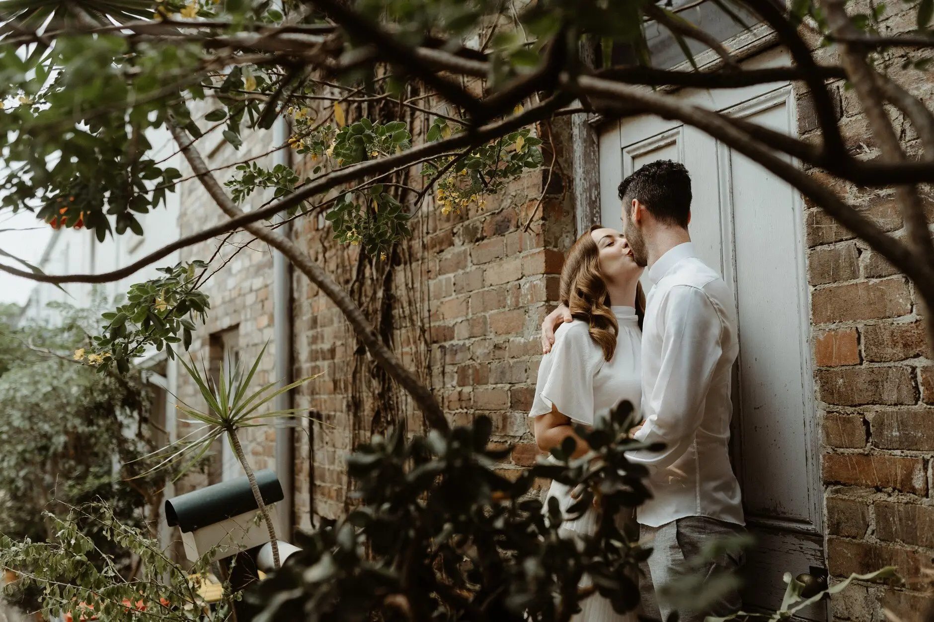 Sophie and Jonathan under a vine-covered archway, Surry Hills