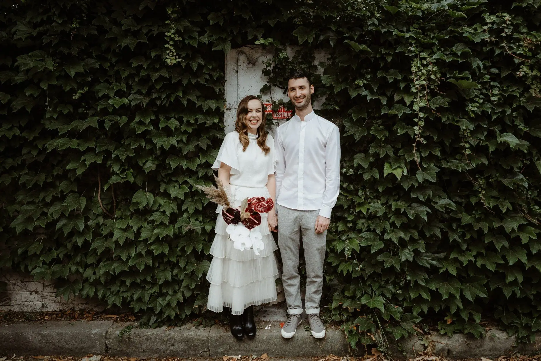 Sophie and Jonathan in front of an ivy-covered wall, Surry Hills