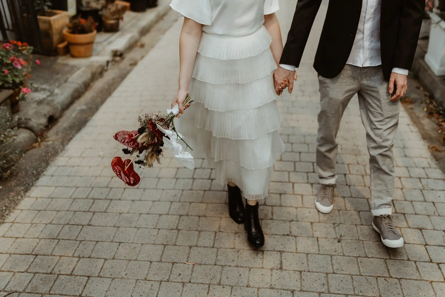 The two of them walking away over the cobbles, bouquet in hand, Surry Hills