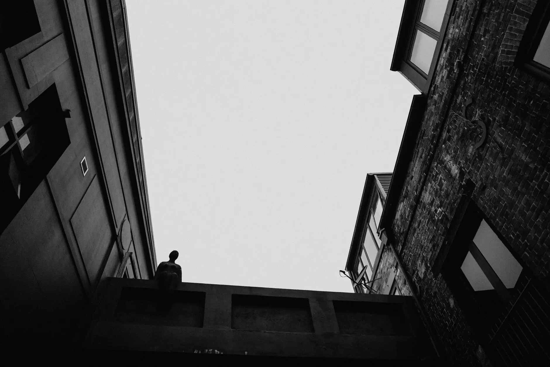 Looking up a narrow Surry Hills lane to a bright strip of sky