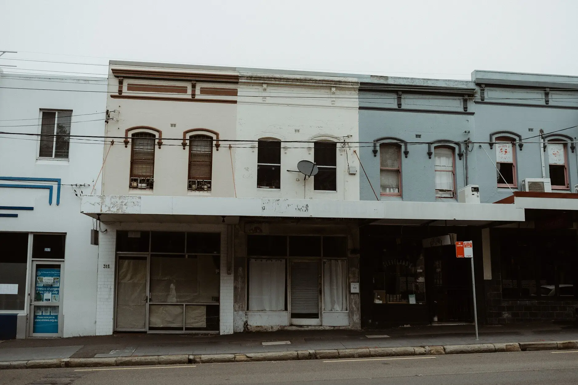 The pale painted shopfronts of a Surry Hills terrace