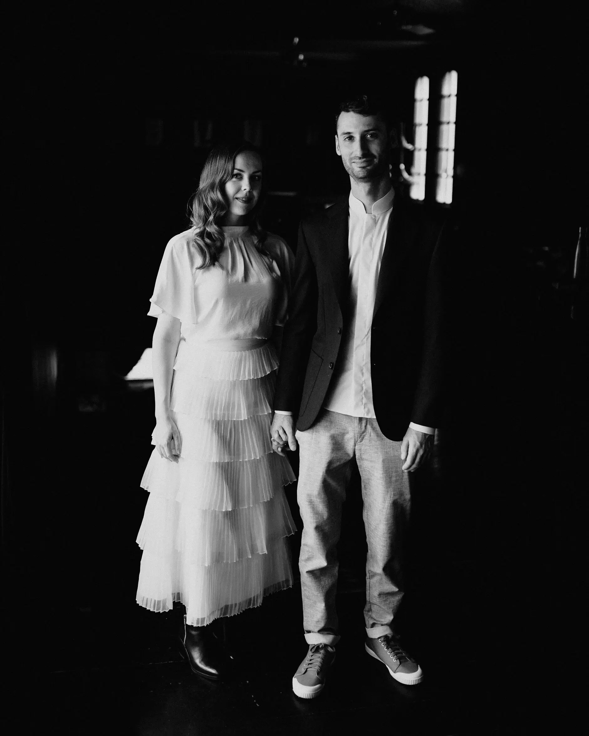 Sophie and Jonathan standing together in the dark doorway, Porteño, Surry Hills