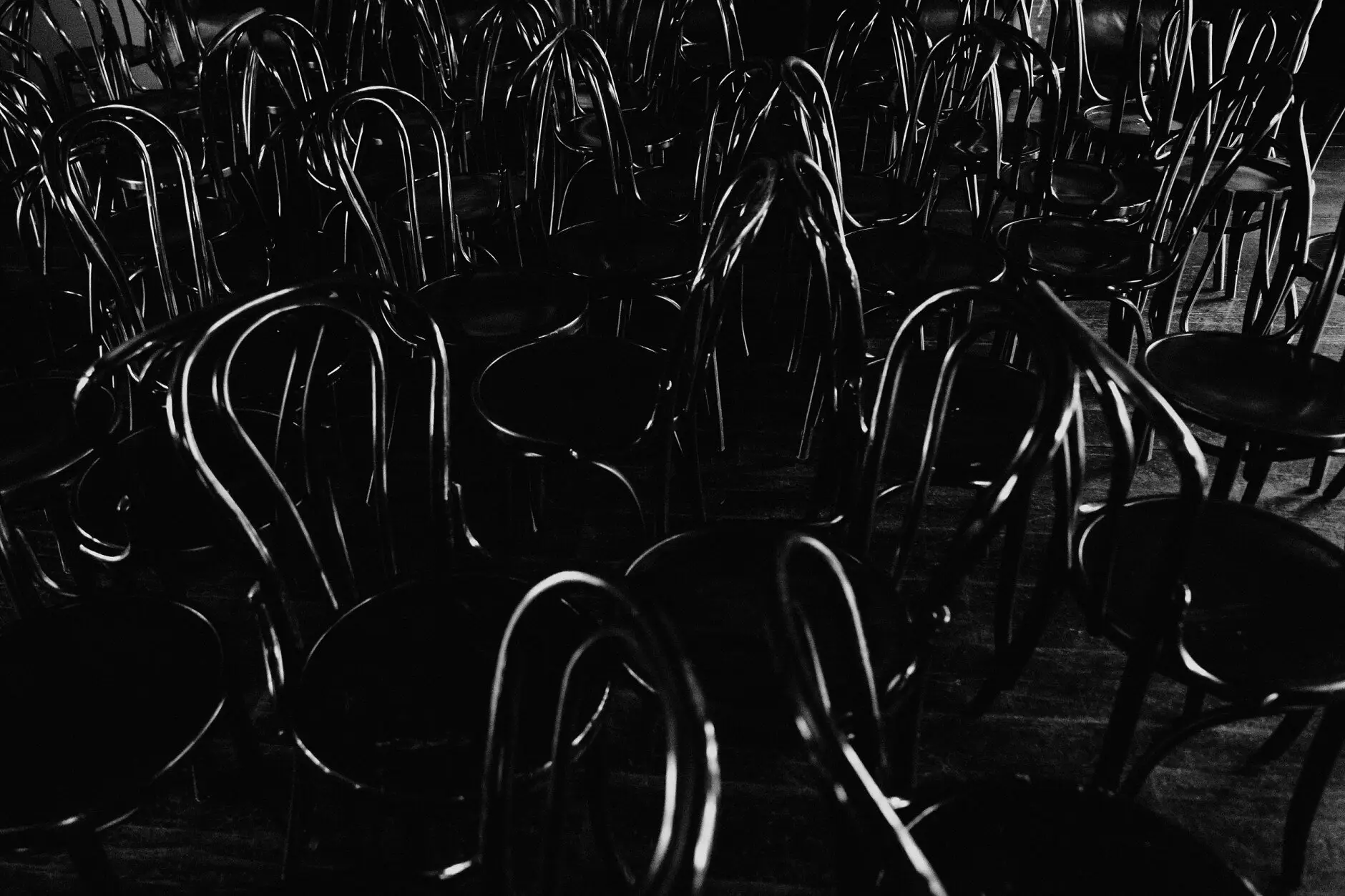 A tangle of stacked bentwood chairs in the dark, Casa, Surry Hills