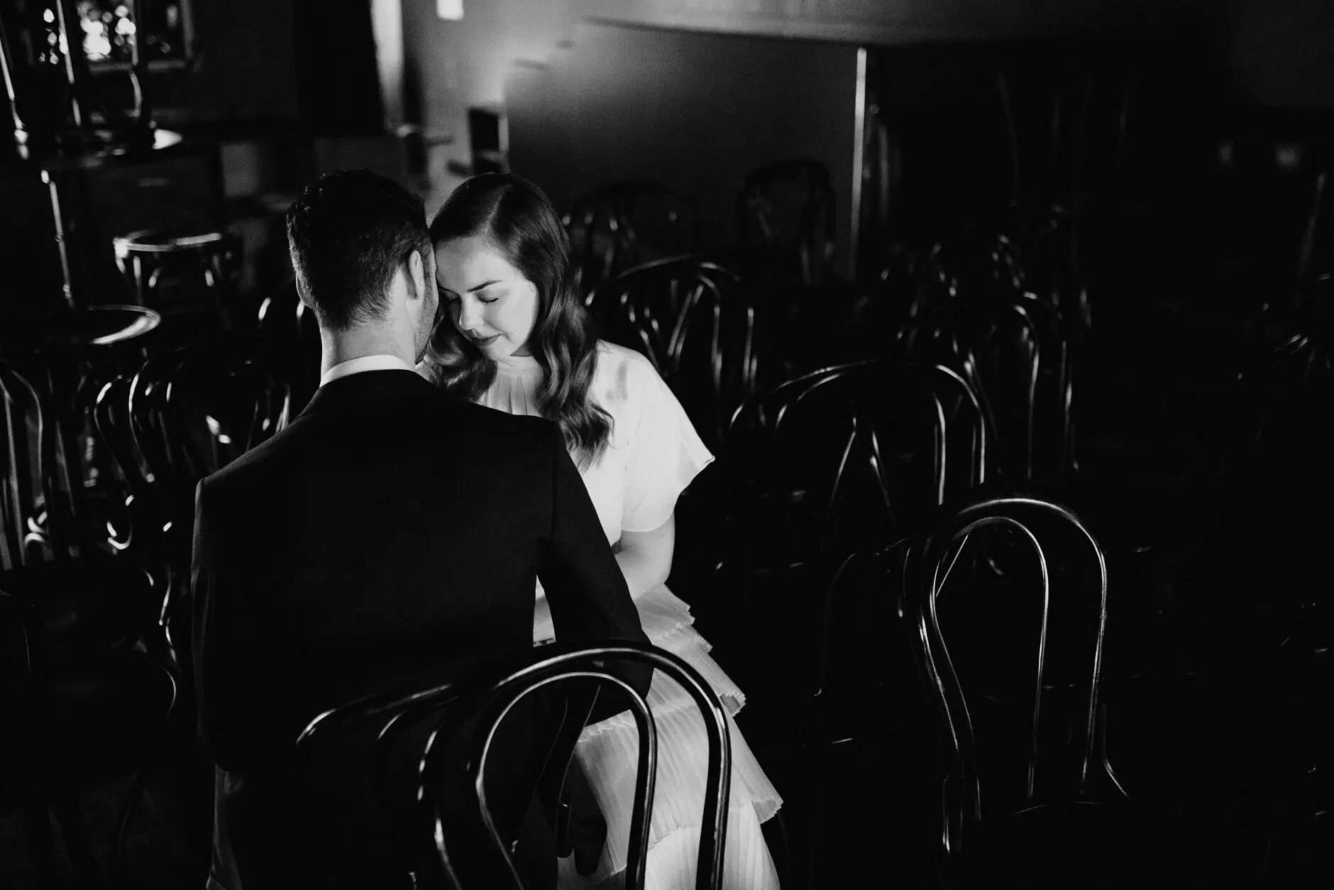 The couple among the bentwood chairs, in black and white, Casa, Surry Hills
