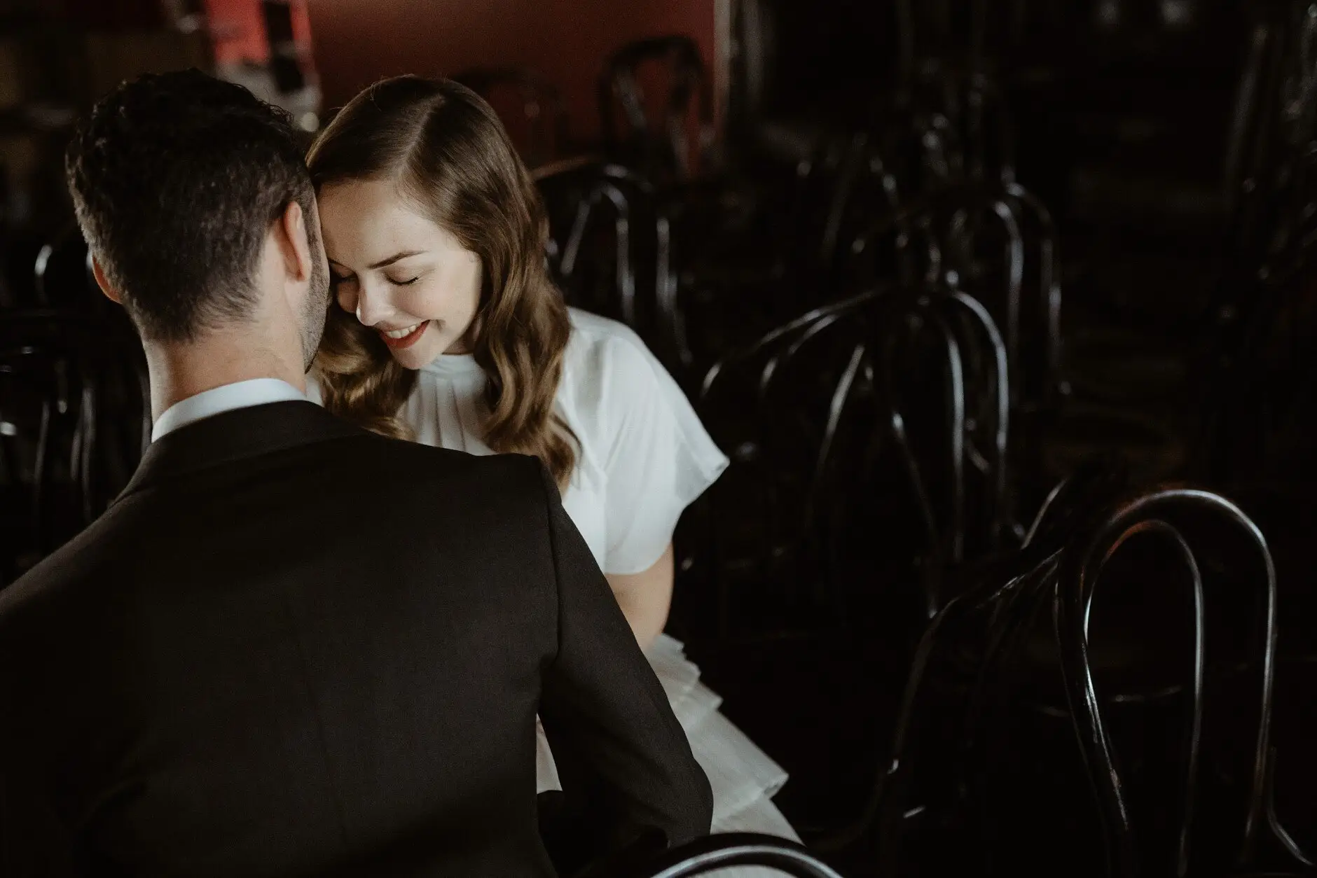 Sophie smiling over Jonathan's shoulder as they hold each other, Casa, Surry Hills