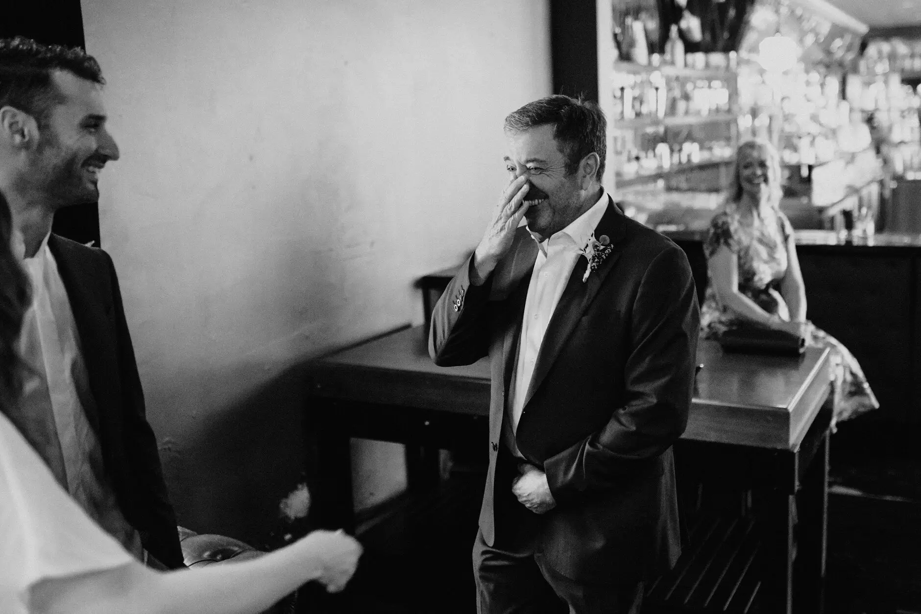 A guest wiping his eye during the ceremony, in black and white, Porteño, Surry Hills