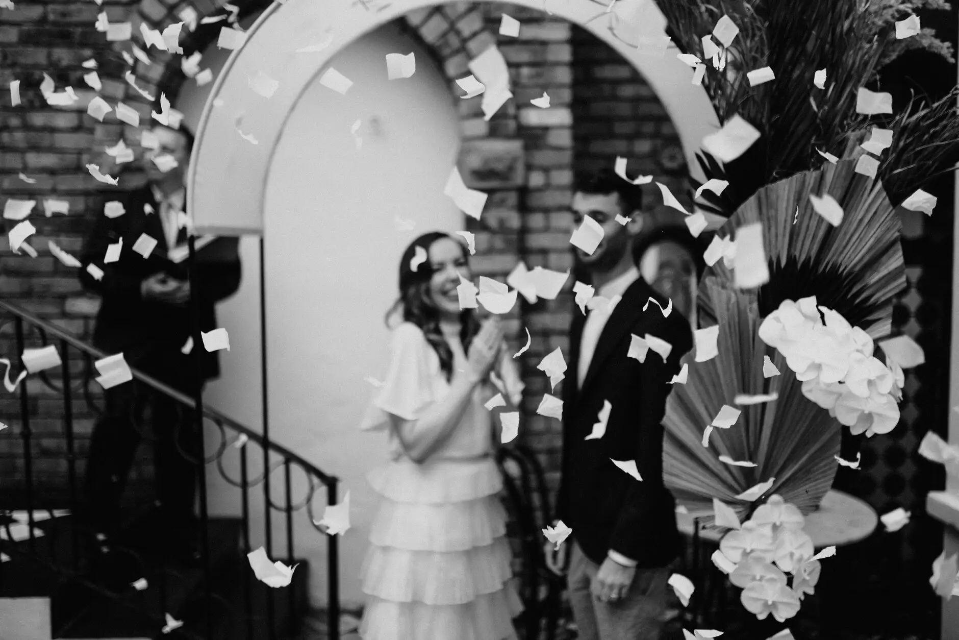 Confetti coming down over Sophie and Jonathan on the stairs, in black and white, Porteño, Surry Hills