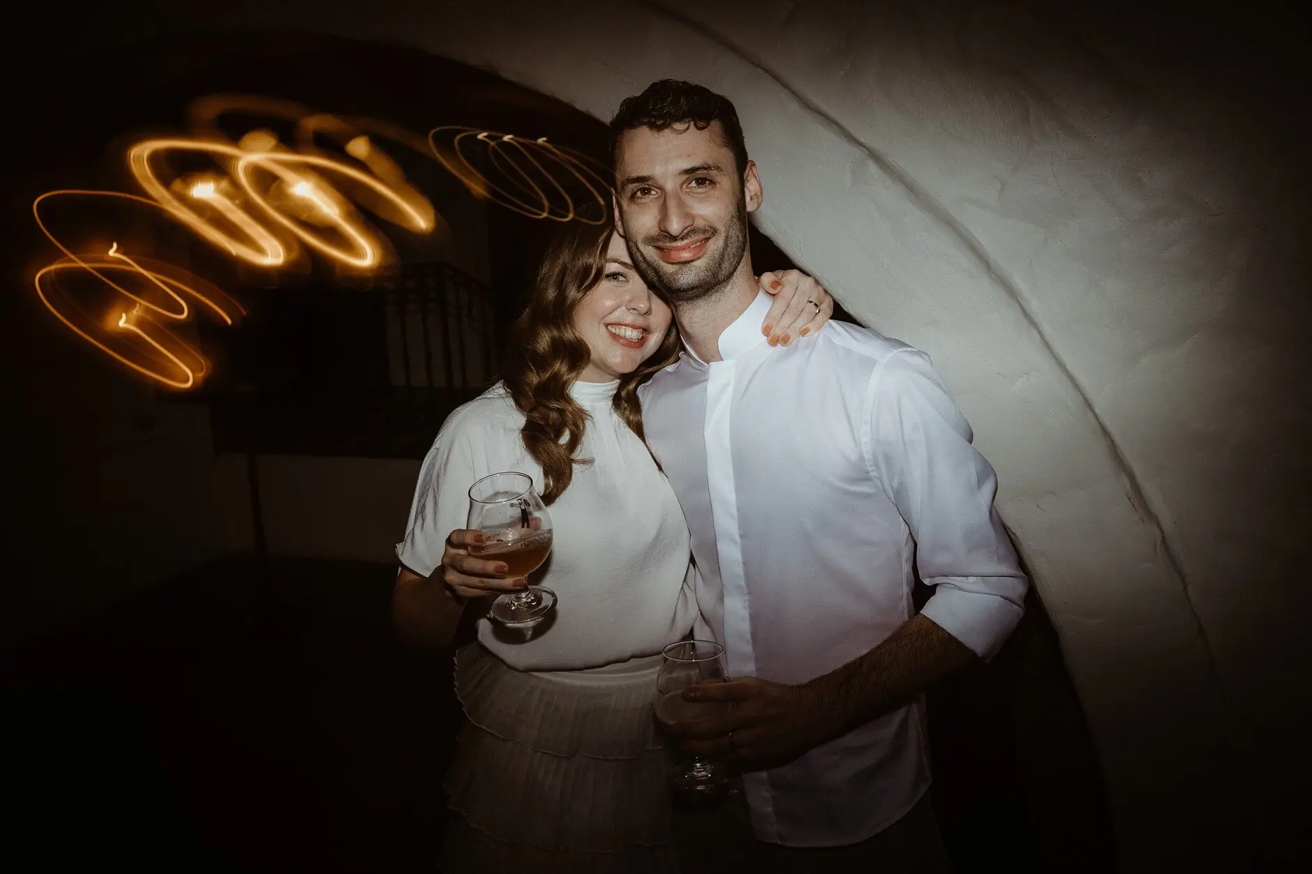 Sophie and Jonathan holding each other in loops of golden light, Porteño, Surry Hills