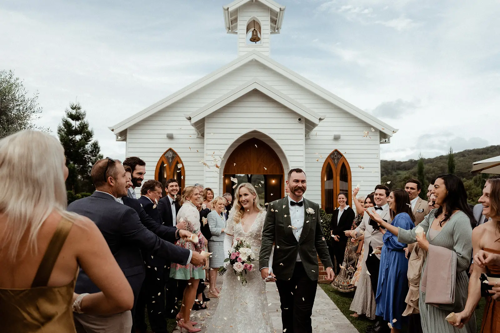 The couple walking back through their guests after the chapel ceremony, The Valley Estate, Currumbin Valley