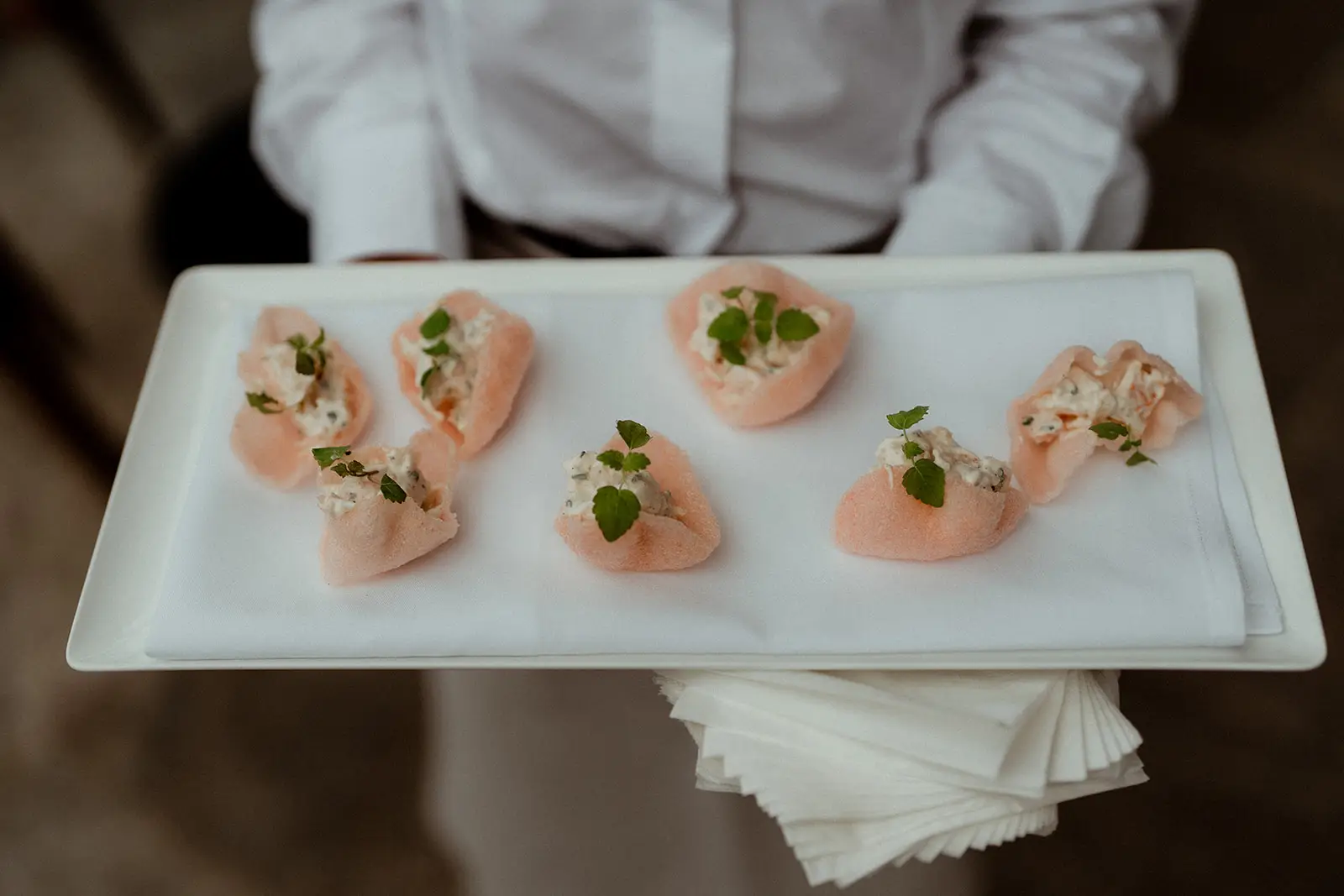A tray of pale canapés being carried out through the reception, The Valley Estate