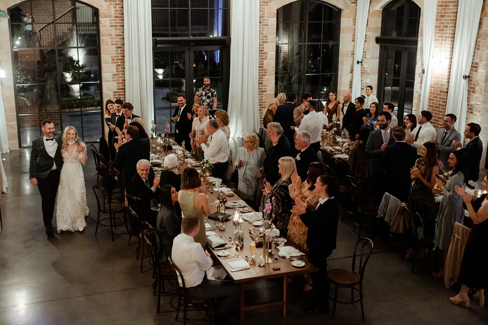 The reception under way beneath white drapes and chandeliers in the brick Manor, The Valley Estate, Currumbin Valley