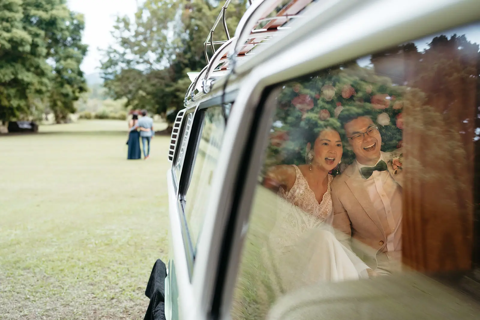 The couple laughing through the kombi window during canapés on the lawn, The Acre Boomerang Hills